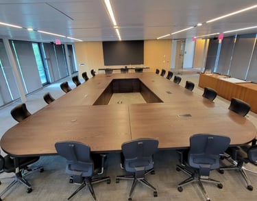 22ft x 14ft custom white ash conference table with fabricated wood legs — full installed view
