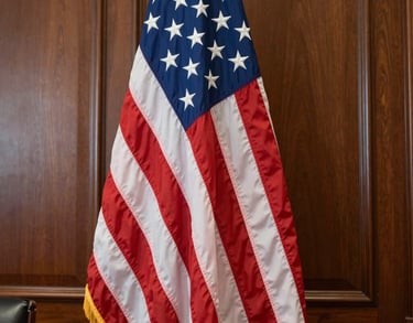 Close-up of a high-quality American flag standing in a wood-paneled federal office, soft natural light, North American / US setting.