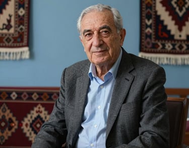 Portrait of a senior math consultant, an elderly gentleman with a kind face, sitting in a room with traditional Anatolian textiles integrated into modern decor, slate blue light.