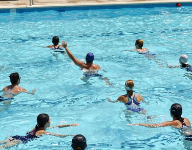 a man riding a skateboard down a street next to tall buildings