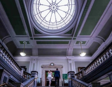 bride and groom walking up the main stairs at Islington Town Hall