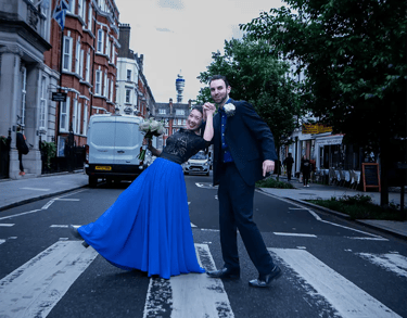 wedding couple walking on a pedestrian crossing