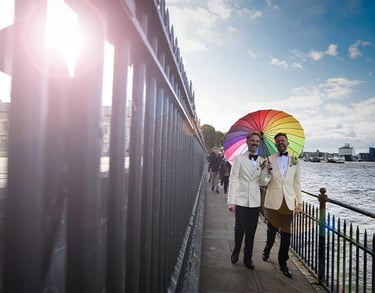 Newly-weds walking alongside the River Thames in Greenwich