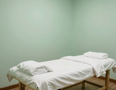 Photography of a serene acupuncture treatment room in a Southeast Asian clinic, featuring a clean massage bed, soft lighting, and a peaceful atmosphere with pastel green walls.