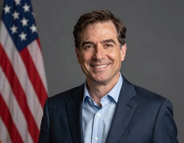 Professional studio portrait of a foundation leader, North American / US style, wearing professional attire with a warm, trustworthy expression.