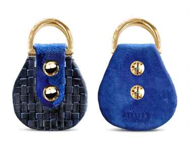 Handmade blue leather key fob with woven textures and gold metal hardware for luxury accessories.