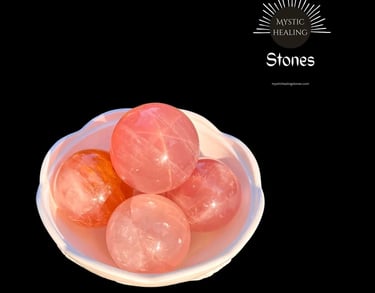 Polished pink rose quartz crystal spheres in a white bowl for healing and meditation.