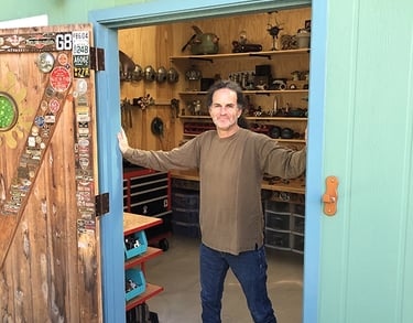 Santa Barbara artist Tal Avitzur standing at the doorway into his workshop.