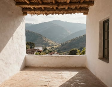 Photography of a wide, open-air terrace with white-washed walls and a thatched roof, overlooking a mountain valley, Latin American / Spanish architecture, morning light, palette of cream and tan.