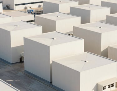 a man riding a skateboard down a street next to tall buildings