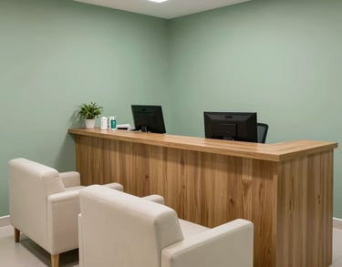 A photography of an organized and clean medical reception area in a Brazilian clinic, featuring a wooden counter, sage green walls, and comfortable off-white seating.
