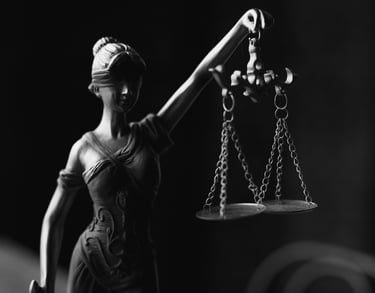 Law image (a figurine of a blindfolded holding a weighing scale)