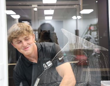 kyler using a squeegee method to clean a window
