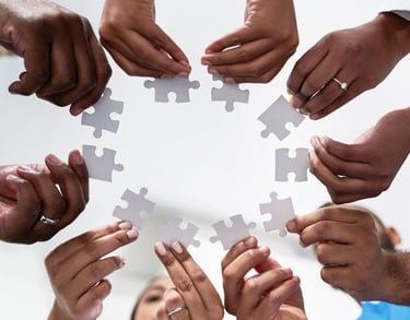 a group of people holding jigsaws