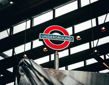 London Underground roundel at the top of an escalator