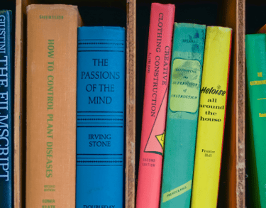 a collection of books on a shelf in a bookcase