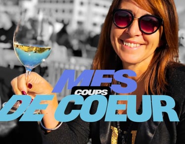 a woman holding a glass of wine in front of a crowd