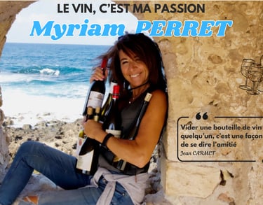 a woman sitting on a stone wall with a greek bottle of wine