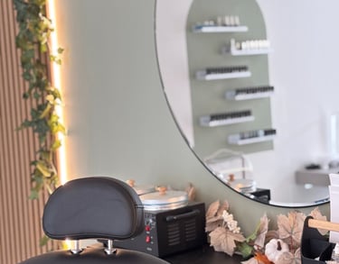 Black beauty chair with a mirror and studio behind.