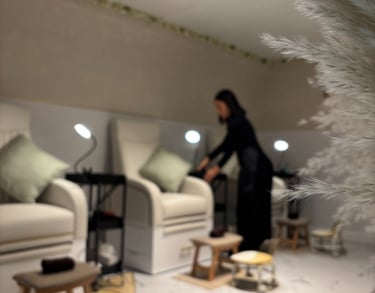 Image of the beauty studio seats, with a person preparing the seat