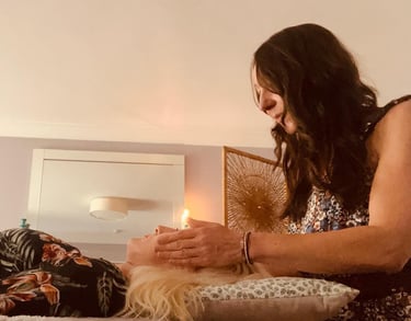 Liv giving reiki to a lady; her hands around her head