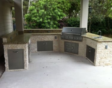 a grilling area with a grill and a grill