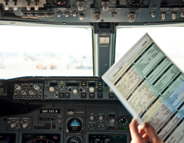 Pilot with flight checklist in cockpit – step-by-step Flight Plan coaching.