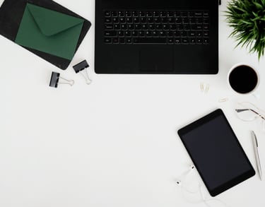 a laptop computer and a tablet on a desk