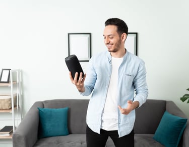 a man in a blue shirt is holding a tablet computer