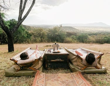 two people lying in an outdoor bath at a wellness safari in South Africa