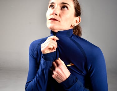 coach Nora zipping up running jacket