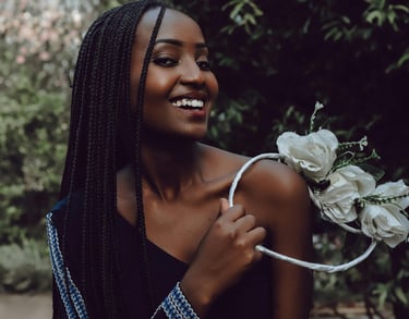 woman holding a ring of flowers