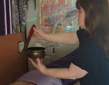 woman holding singing bowl during a reiki healing session