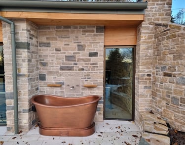 Outdoor bath area with purbeck stone and lime mortar