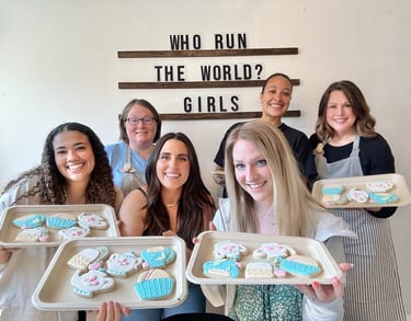 happy people holding their decorated cookies