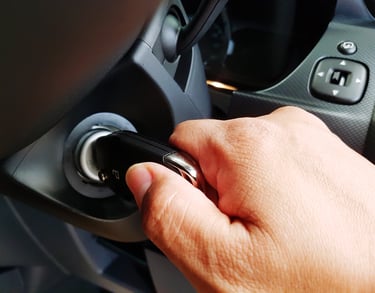 a person's hand is pressing a push start button on a car