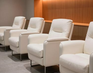 Photography of a modern recovery lounge for athletes, featuring white leather chairs and orange lighting accents. Minimalist and professional.