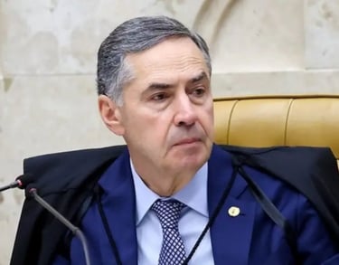 a man in a suit and tie is sitting at a microphone