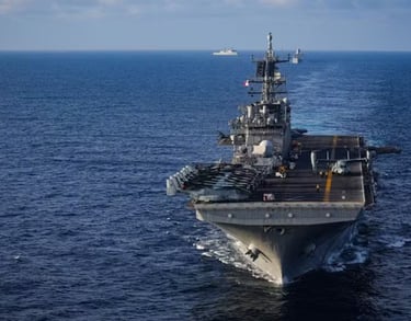 a large ship in the water with a large ship in the background