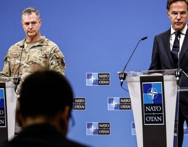 two men in suits and ties standing at podiums