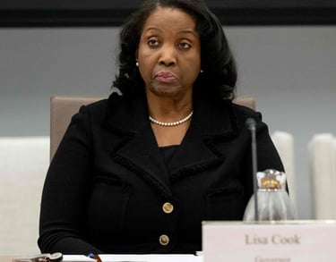 a woman in a black jacket and pearls necklaces