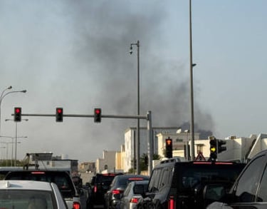 a traffic light on a busy street with smoke billowing