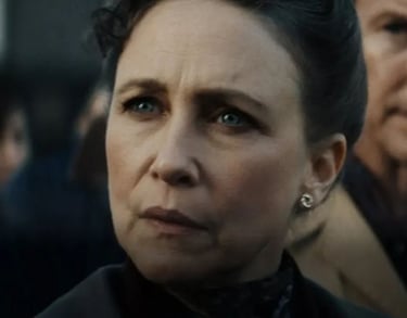 a woman with a black hair and a man in a suit