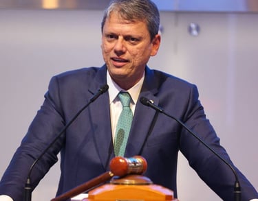 a man in a suit and tie is speaking into a microphone