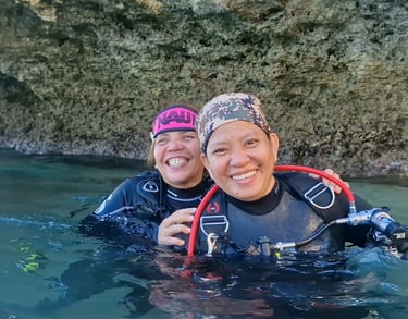 Scuba diver sisters having fun
