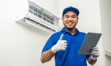 a man in a blue shirt and gloves holding a tablet computer