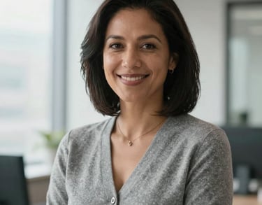 Portrait of a North American professional woman with a welcoming expression, wearing a smart gray cardigan, bright natural office light, professional photography.