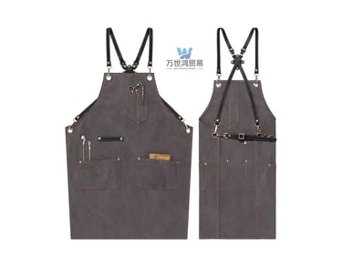 Professional grey canvas barber apron with cross-back leather straps and multiple tool pockets.