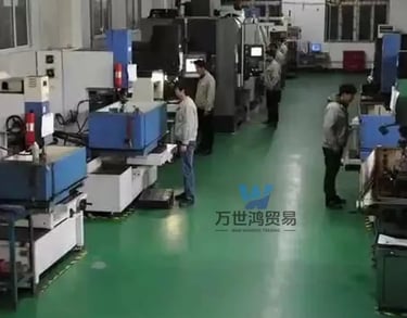 Technicians operating CNC machinery on a modern factory floor for precision industrial manufacturing.