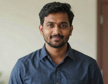 Portrait of a South Asian / Indian man in a smart-casual shirt, looking into the camera with a friendly and trustworthy expression, soft daylight.